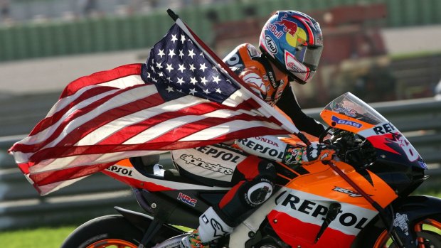 Hayden holding a US flag after winning the world championship GP at the Cheste racetrack near Valencia, Spain in 2006.