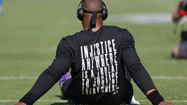 Carolina Panthers' Cam Newton wears a shirt with a quote by Martin Luther King as he warms up.