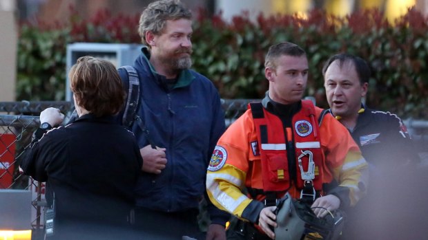 Louis Jordan, second from left, walks from the Coast Guard helicopter to the Sentara Norfolk General Hospital.