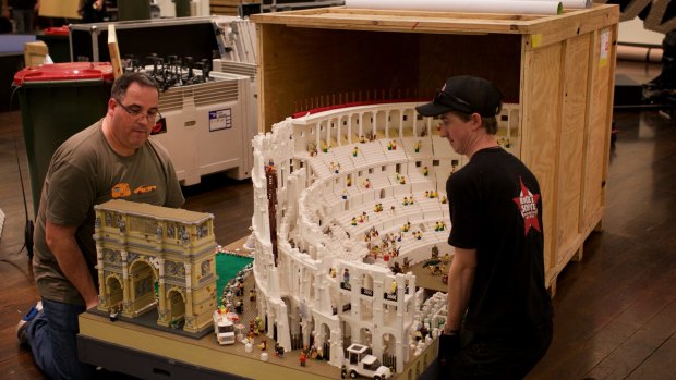 Lego builder Ryan McNaught, left, and a worker set up for the Lego exhibition at the Town Hall in Sydney.
