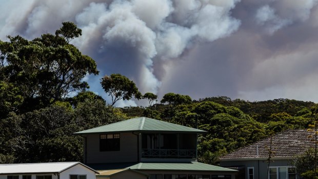 An out-of-control bushfire burning in the Royal National Park, as seen from Bundeena.