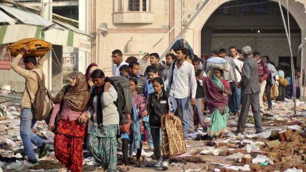 Coming out: People leave the ashram of Baba Rampal on Wednesday.