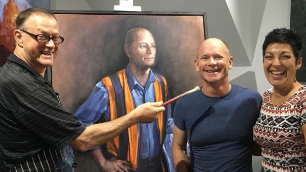 David Hinchliffe in his studio with Campbell and Lisa Newman and his portrait of the former premier.