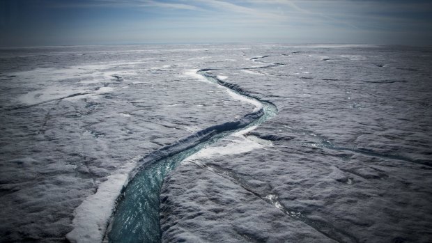 Meltwater flows along a supraglacial river on the Greenland ice sheet, one of the Earth's biggest and fastest-melting chunks.
