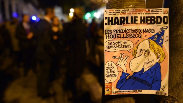 The front page of the last issue of the French satirical newspaper is seen in Madrid.