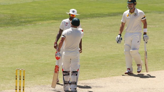 India's Shikhar Dhawan and Australian opener David Warner exchange words on the fourth day of the first Test as Shane Watson looks on.