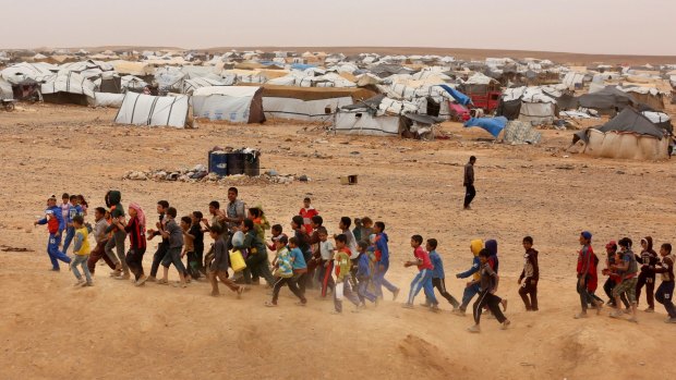Syrian refugee boys await approval to enter Jordan.
