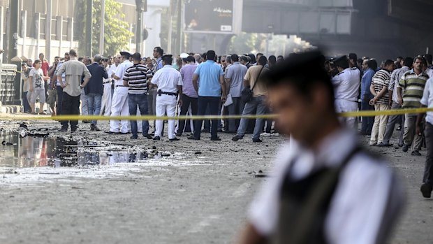 A crowd gathers outside the Italian consulate following the blast.