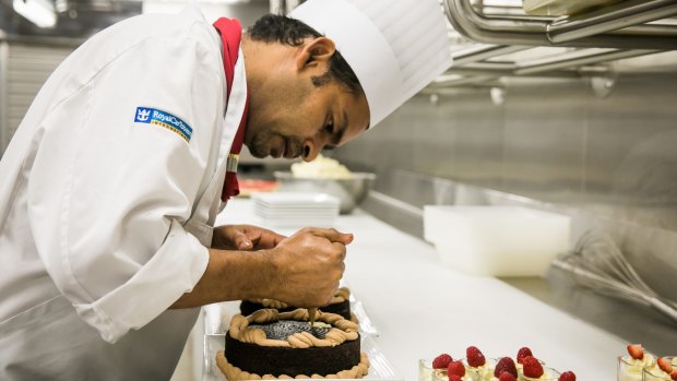 Chefs preparing food in the kitchens on board Ovation of the Seas cruise ship.