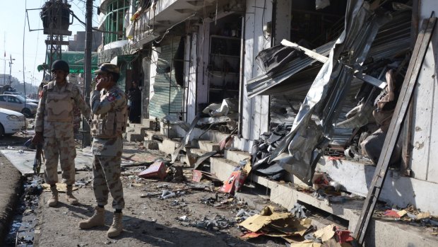 Pakistani para-military troops inspect the site of a bomb blast in Quetta, Pakistan.