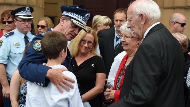 NSW Police Commissioner Andrew Scipione comforts the family of slain police officer Bryson Anderson.