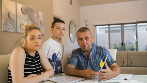 Chantelle, Ethan,10, and John Ireland at their home in Forde. The home has structural damage which QBE insurance is refusing to cover. 