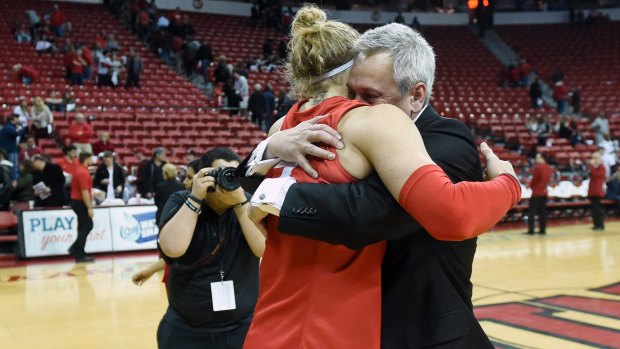Job well done: Head coach Craig Neal hugs Hugh Greenwood after New Mexico defeated the UNLV Rebels 71-69 at the Thomas & Mack Center in Las Vegas, Nevada.  