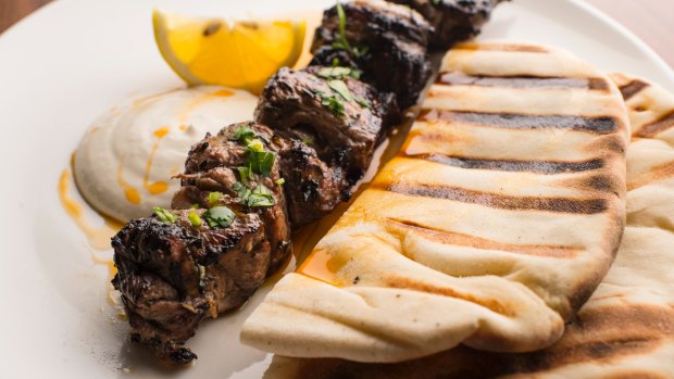 Skewered lamb rump with grilled flatbread and a squeeze of lemon.