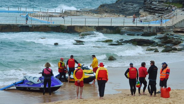 Surf Life savers and rescue prepare to enter the water in the search at Curl Curl Beach.