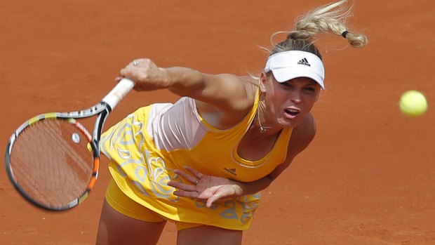 Denmark's Caroline Wozniacki serves to Italy's Karin Knapp.