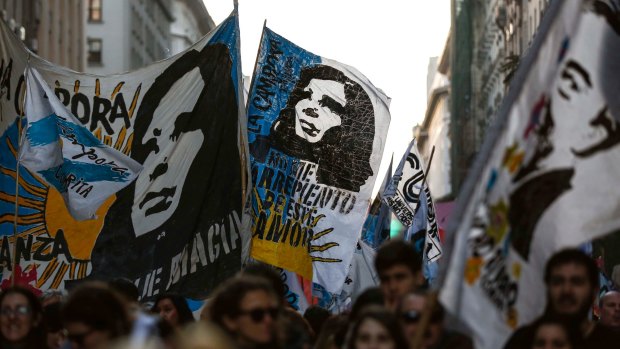 Demonstrators waving flags featuring images of former president Cristina Fernandez and late president Nestor Kirchner approach Plaza de Mayo in Buenos Aires in September.
