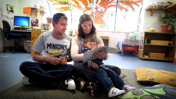 The Rohrlach family read the Mr Fluffy book. Rebecca and Matthew with son Trent, two.