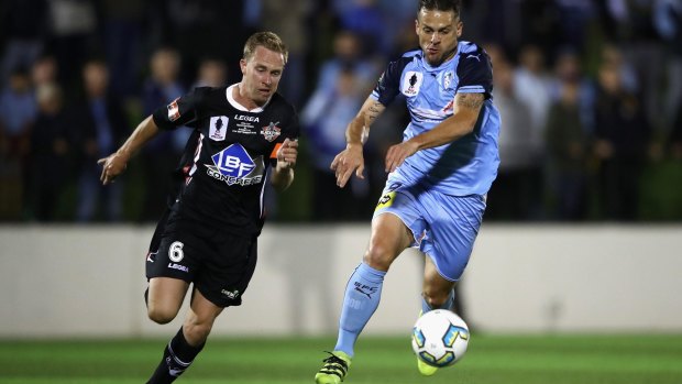 Bobo of Sydney FC contests the ball with Matthew Lewis of Blacktown City on Wednesday night.