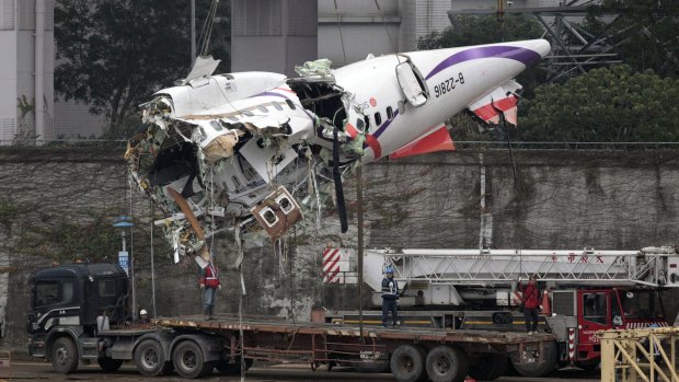 The main fuselage from TransAsia Airways Flight 235 is hoisted away on Thursday. 