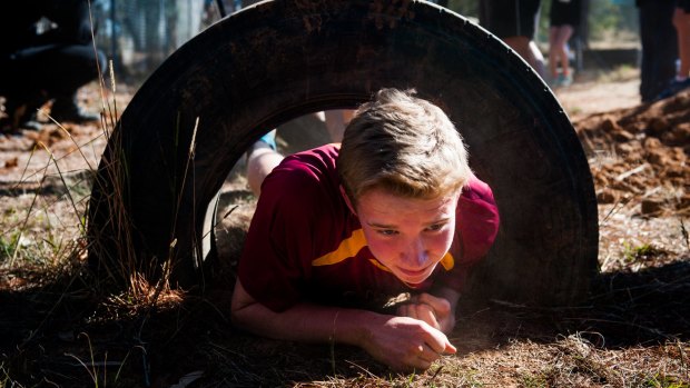 Campbell High School student Owen Hanna, 15, works his way through one of the big tyres.