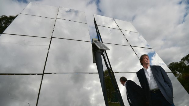 John Lasich, chief technology officer at RayGen, stands in front of mirrors used to concentrate sunlight onto a highly efficient solar receiver to produce electricity under the Victorian-based project.