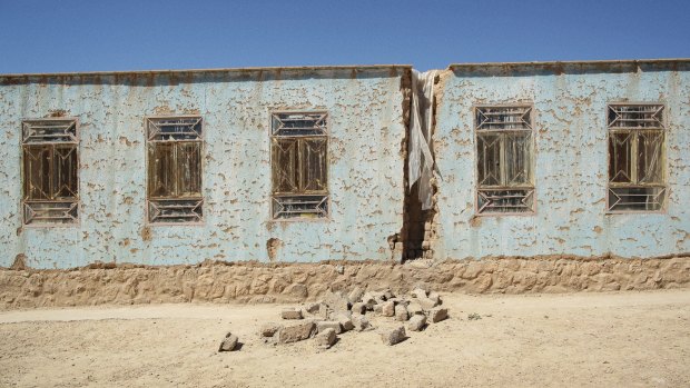 The crumbling exterior of a school, which was funded by Australia, in the village of Sajawol.
