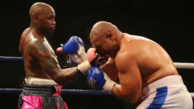Malik Scott dishes out punishment to Alex Leapai during the heavyweight fight at the Logan Metro Sports Centre in Brisbane on Friday.
