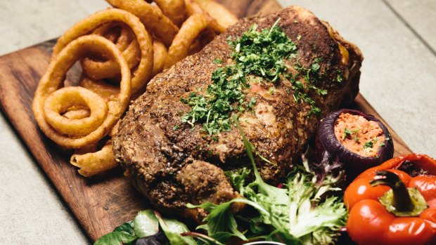 Slow cooked lamb shoulder with a serve of onion rings.