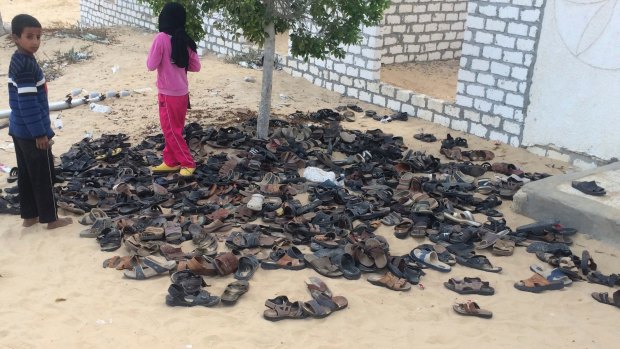 Discarded shoes of victims remain outside Al-Rawda Mosque in Egypt. a day after attackers killed more than 300 worshippers.