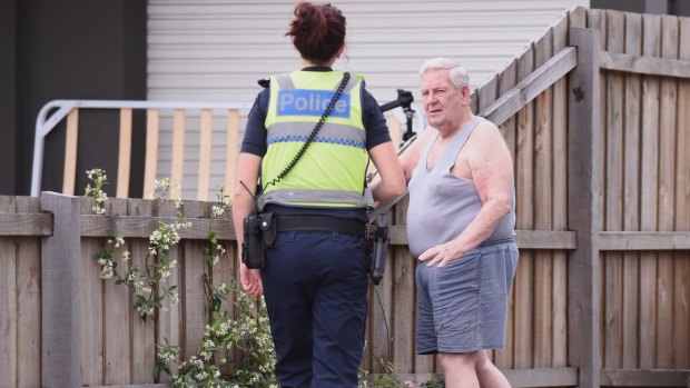 Police speaking to the neighbour next to the Sunshine home where a woman is believed to have been shot on November 23.