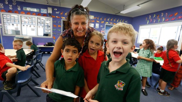 Indigenous language classes at Dubbo West Public School: Dianne McNaboe, teacher of Aboriginal language and culture, with Bryson (left), Lily and Thomas singing a song. 