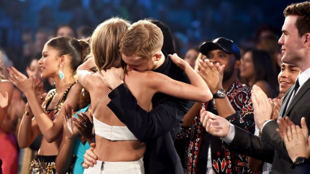 Taylor Swift embraces Calvin Harris after winning the Top Artist award at the 2015 Billboard Music Awards.