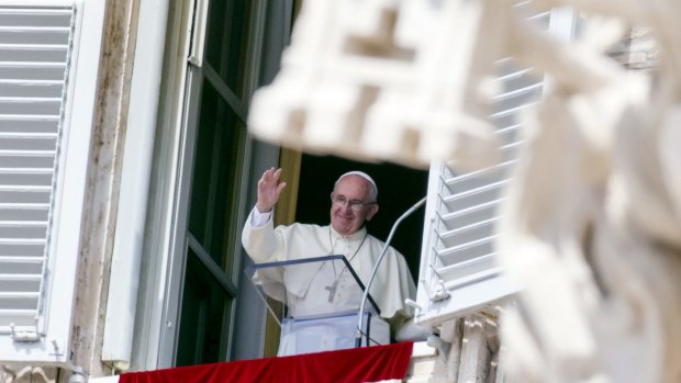 Pope Francis waves from his window overlooking St Peter's Square on Sunday. 