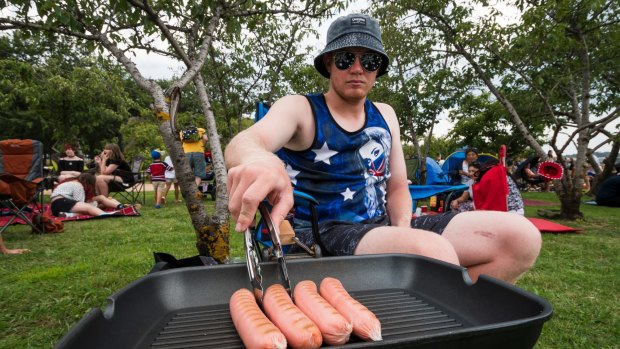 Michael Boustead cooking up some snags during the Australia Day Capital Concert.
