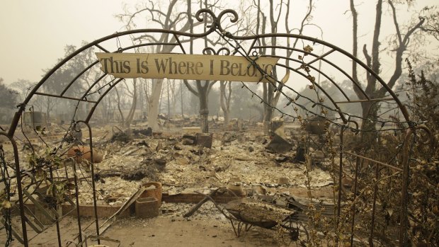 A sign hangs above an entryway to a home destroyed by Sunday's fire in Middletown, California.