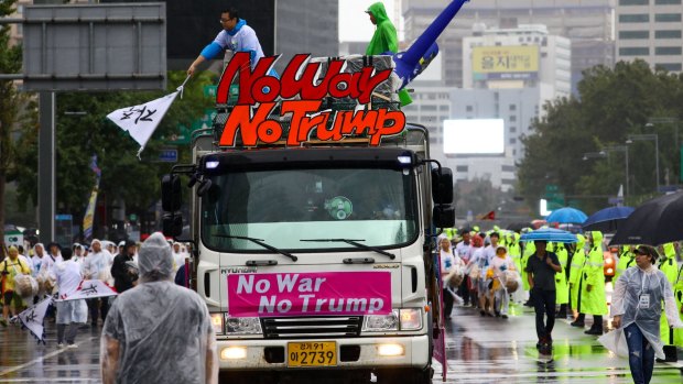 A truck carries a placard reading 'No War No Trump' following a rally against the deployment of the Terminal High-Altitude Area Defense system in Seoul, South Korea, on Tuesday, Aug. 15, 2017.