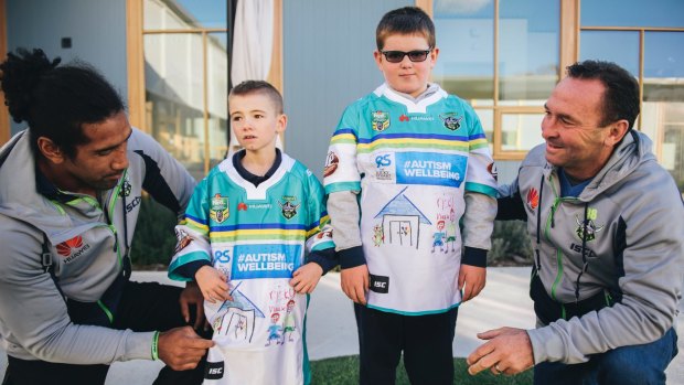 Sia Soliola and Ricky Stuart meet with Jayden, 8, and Max, 12, to give them the special jerseys they helped design for the Ricky Stuart Foundation.