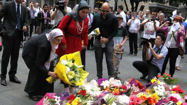 Opposing terror: Members of the Muslim community lay flowers in Martin Place, Sydney, after two people and a gunman died in a siege in December last year.