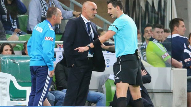 Referee Kris Griffiths-Jones has a word with Victory coach Kevin Muscat during Friday's match.