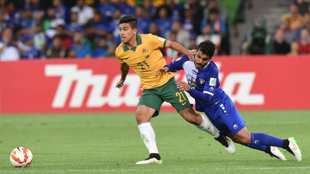 Man of the match: Massimo Luongo fights for the ball with Faisal Zayed Alharbi of Kuwait.