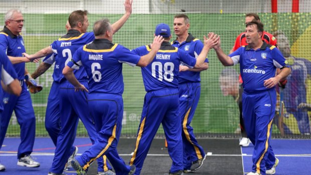 The ACT Over-50s team celebrate a wicket at the Australian Masters Championships.