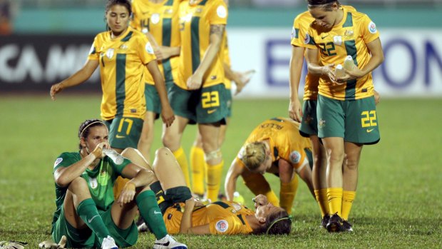 Dejected: The Matildas after their Asian Cup loss in 2014.