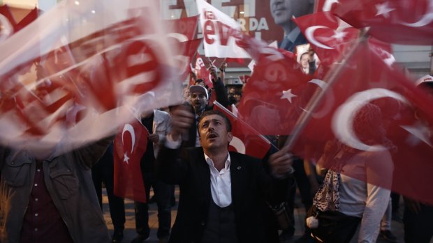 Residents wave Turkish national flags in Istanbul, Turkey's largest city, where most voters chose 'No'.