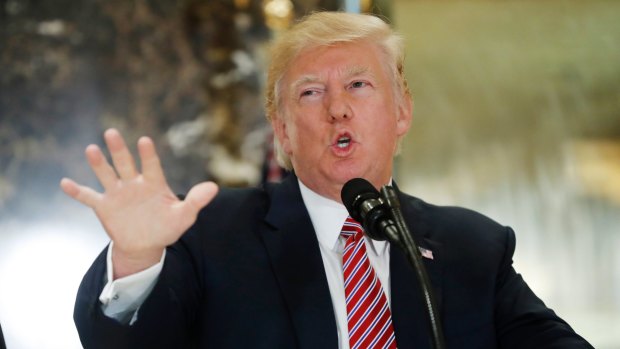 US President Donald Trump speaks to the media in the lobby of Trump Tower in New York.