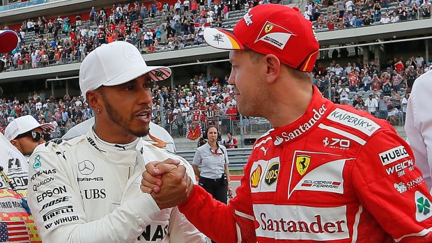 Mercedes driver Lewis Hamilton is congratulated by Ferrari's Sebastian Vettel.