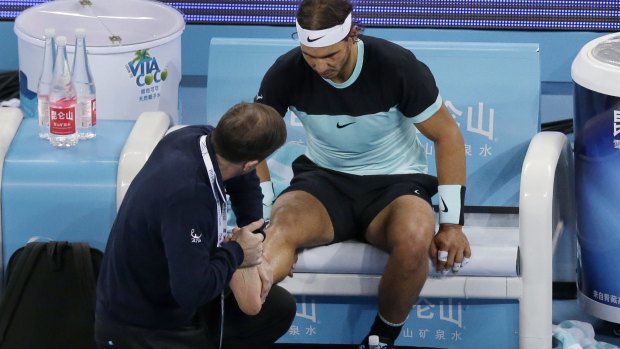 Rafael Nadal receives treatment on his foot.