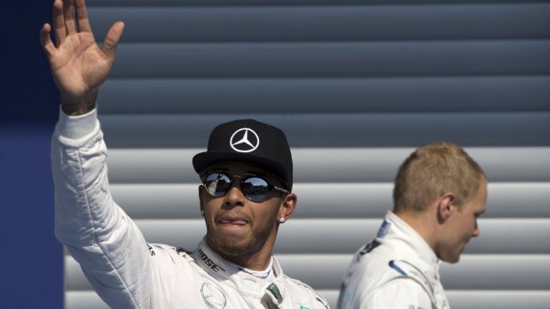 Lewis Hamilton of Britain celebrates his pole position victory.