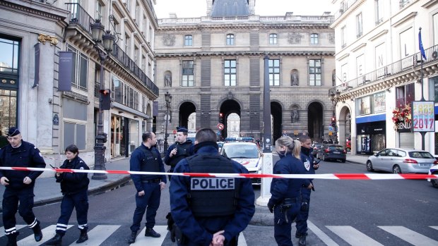 Police officers cordon off the area next to the Louvre after a soldier opened fire.