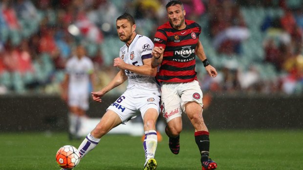 Battling: Western Sydney's Frederico Piovaccari and Glory opponent Dino Djulbic contest possession.